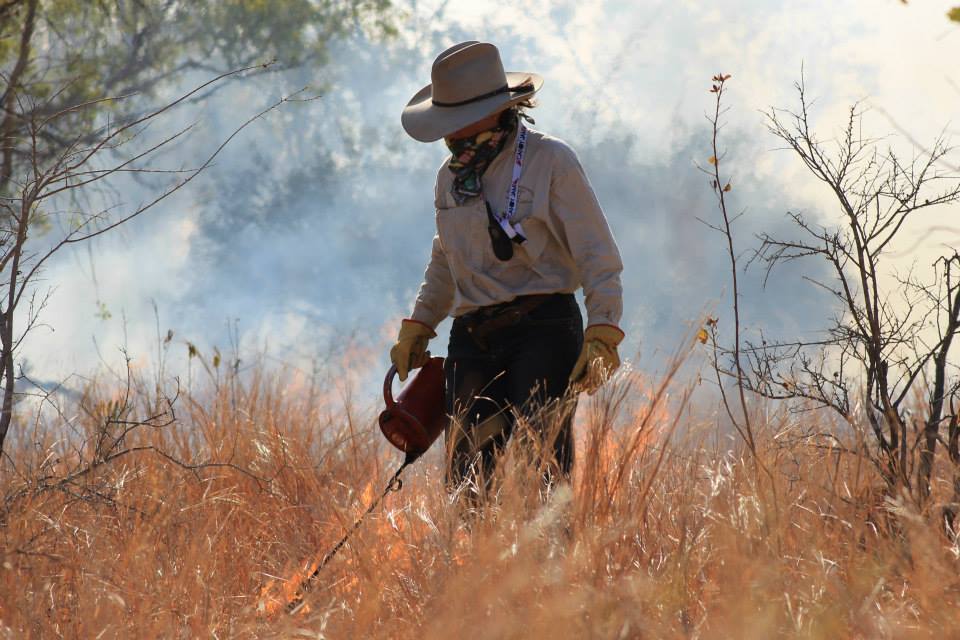 Dionne Walsh conducting a back burn - grass on fire.