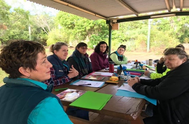 Women sit at a table at an event funded by the Drought and Climate Adaptation Program (DCAP)