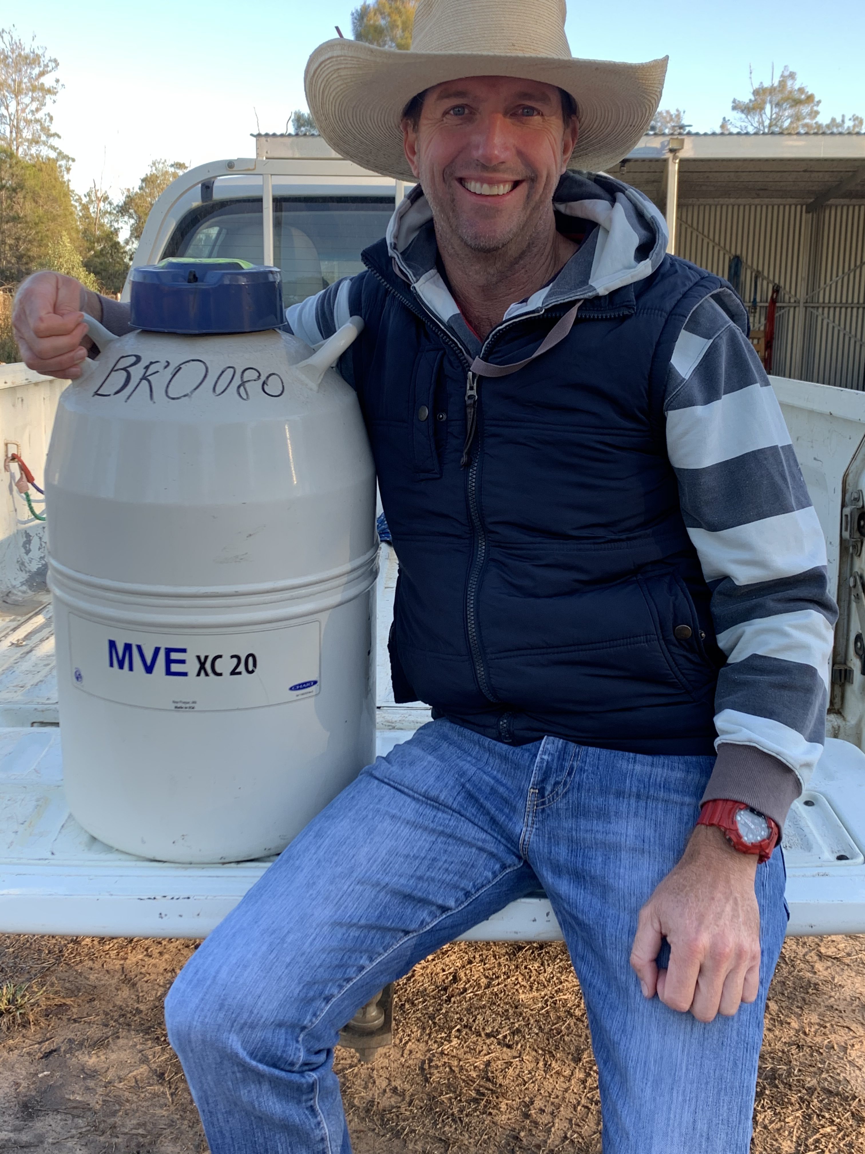 Matt Brown with a semen storage tank on the back of a vehicle.