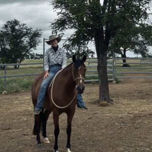 Caity Kelly, NT DAF sitting on horse in yard.