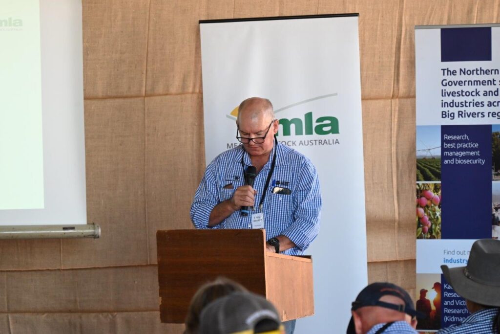 Photo of Phil Hausler at lectern with microphone inviting people to the Kidman Springs BeefUp forum.