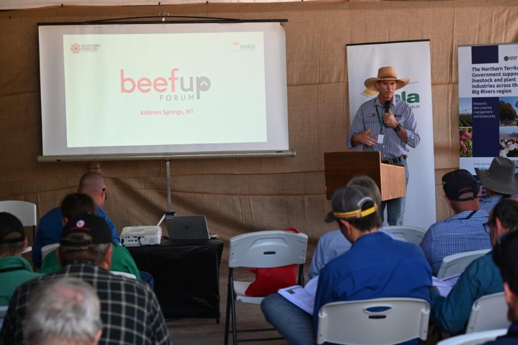 Photo of Tim Schatz standing in front of seated forum participants with microphone.