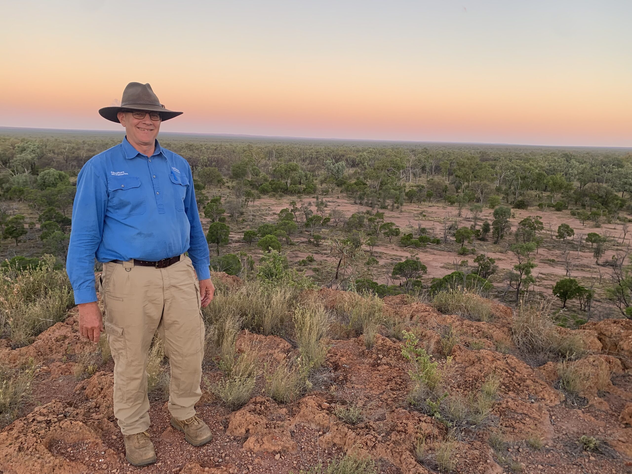 Paul standing in front of a sunset at Jericho.