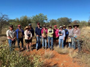 Participants at a rangeland management course standing in a paddock in central Australia