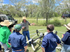 Carl Anderson showing students a spraying drone at Callide Dawson Carcase Competition 2026