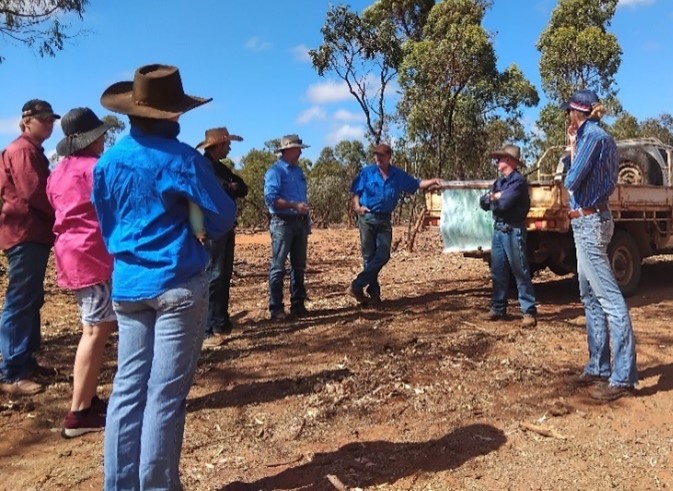 Members of the Torrens Creek Producer Group stand in a circle in deep discussion.