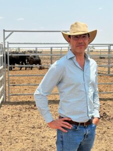 A/Prof Luis Prada e Silva standing in front of cattle in yards
