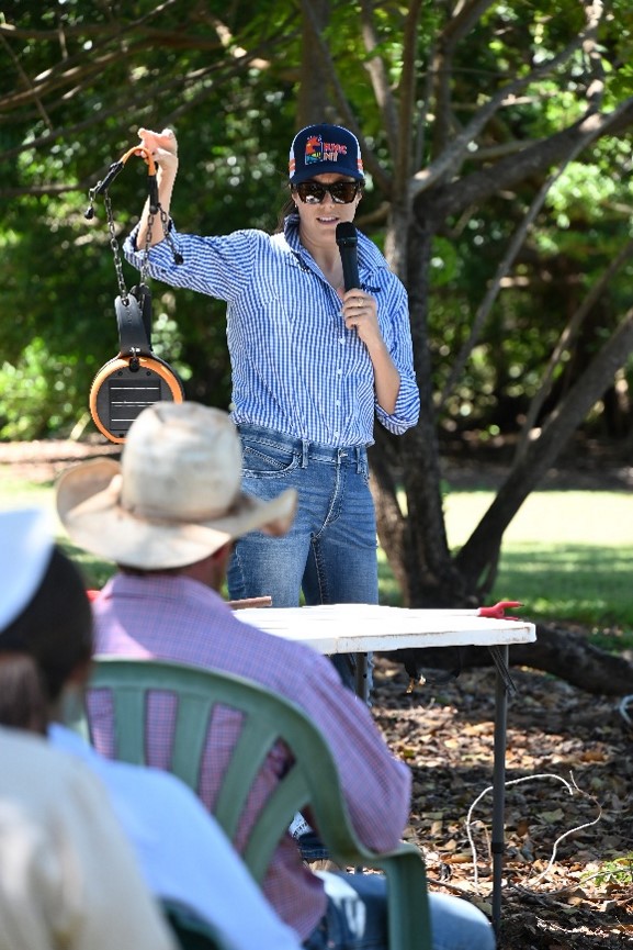 Christie Pearson, DAF, holds up an eShepherd virtual fencing collar at the DDRF field day