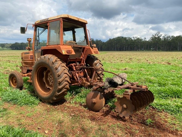 Tractor pulling a plough.