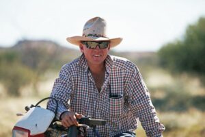 Paul Smith, Tieyon Station, NT sitting on a motorbike.