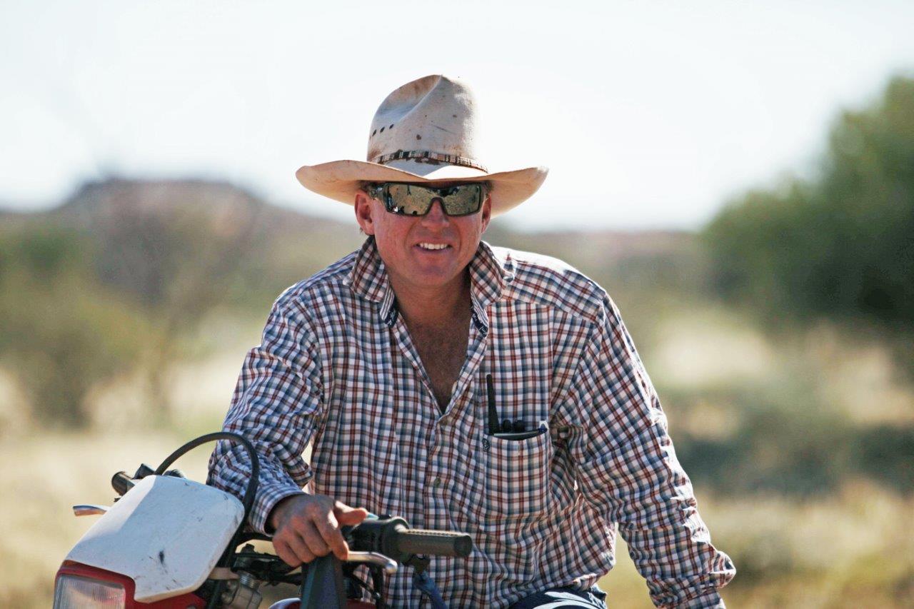Paul Smith, Tieyon Station, NT sitting on a motorbike.