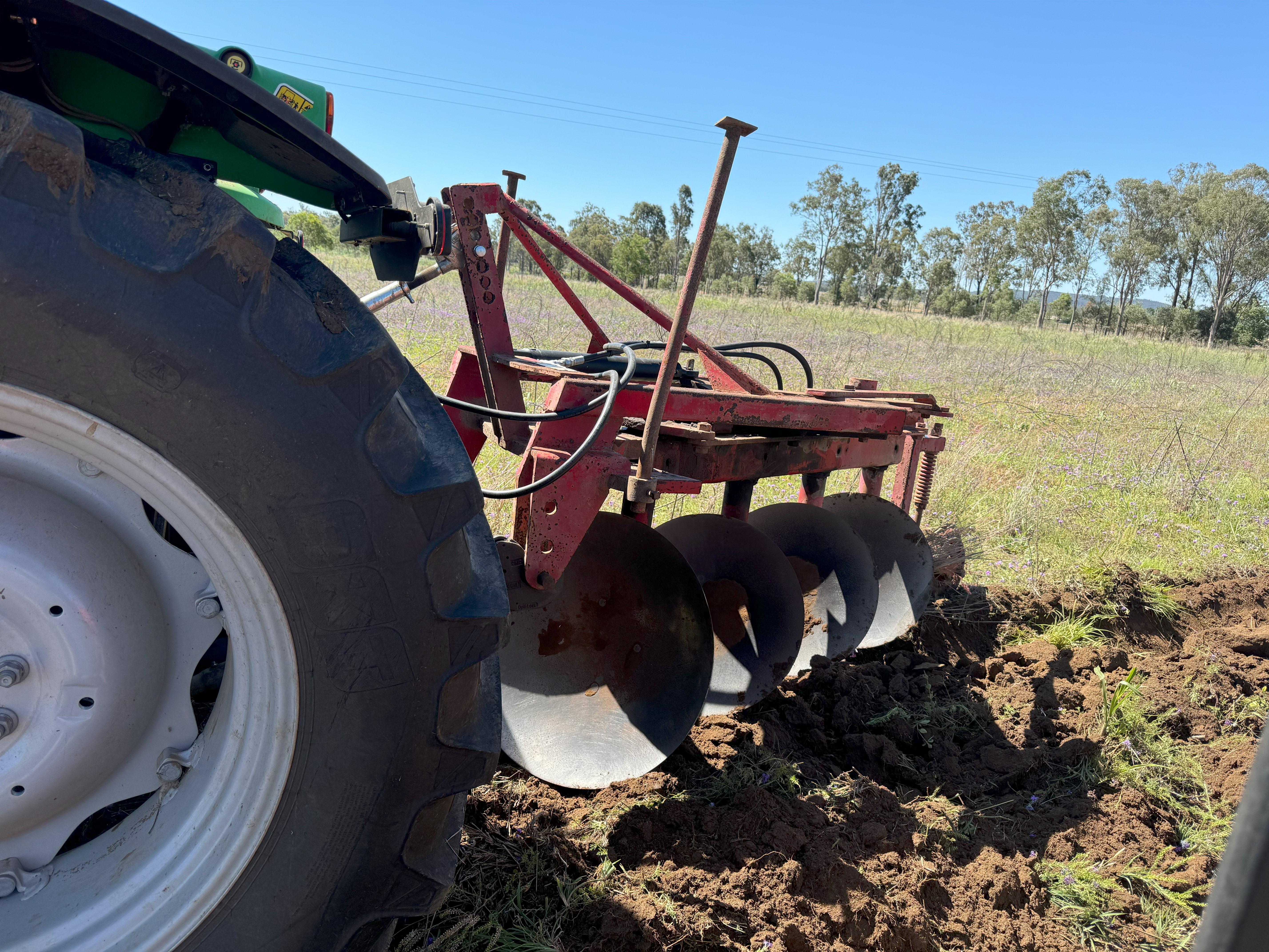 Producer near Goomeri showing fellow members how a reversible plough works up country.