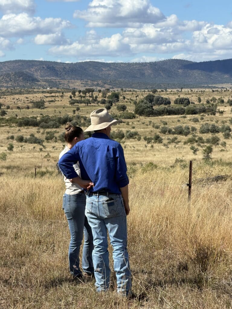 Two producers assessing their pasture